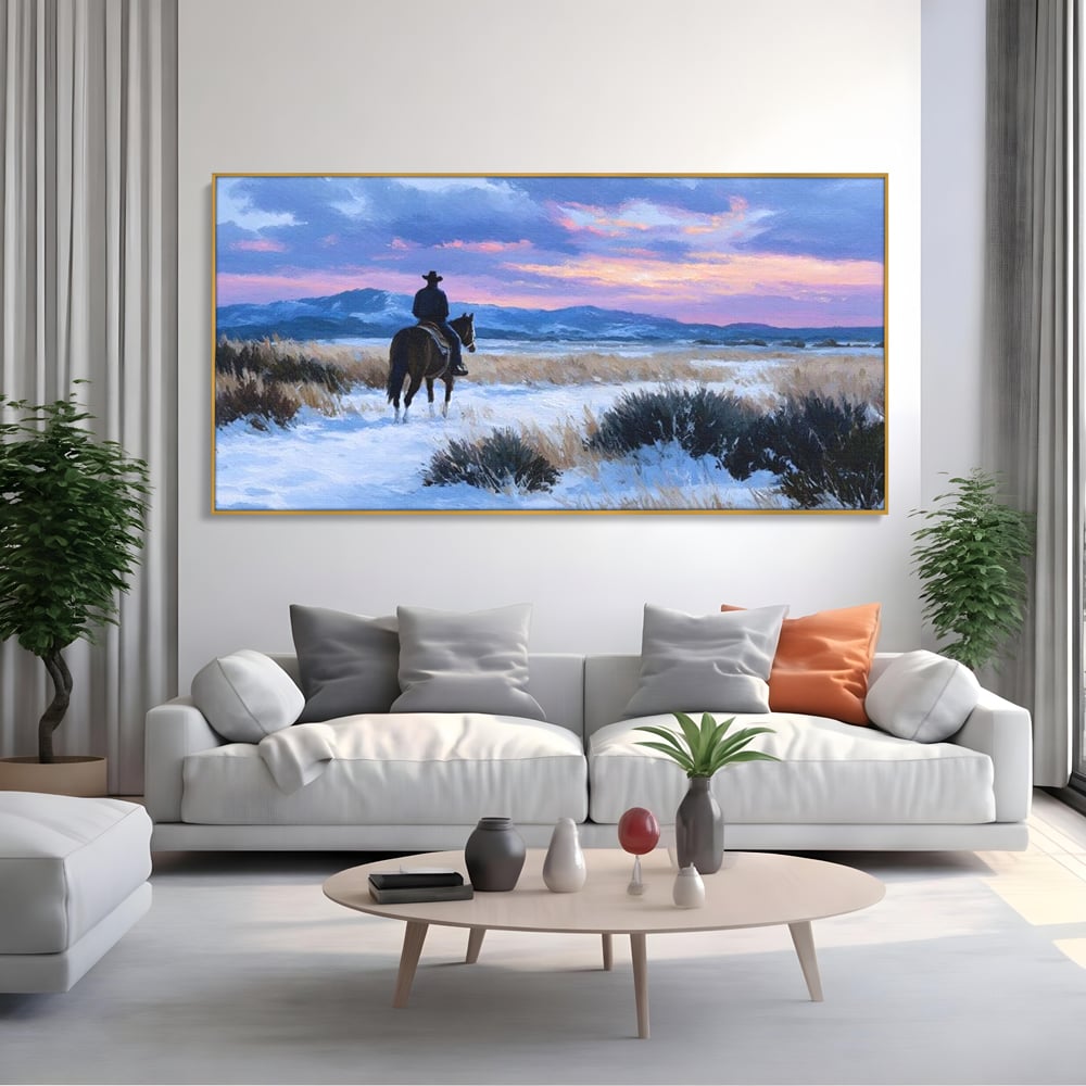 Tablou canvas cu pictura cu calaret cowboy in zapada, in rama de aluminiu auriu, pe perete intr-un living